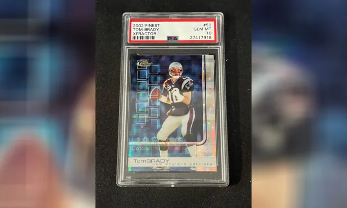 A 2002 Topps Finest X-Fractor card showing football quarterback Tom Brady rests inside a transparent case in Gorham, Maine, on Jan. 19, 2022. (Troy Thibodeau/Saco River Auction LLC via AP)