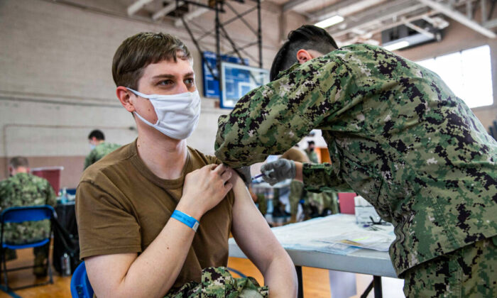 A Navy member gets a COVID-19 vaccine on Naval Station Norfolk in Norfolk, Va., in a file image. (U.S. Navy/Mass Communication Specialist Seaman Jackson Adkins via The Epoch Times)