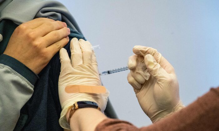 An adolescent receives a Pfizer-BioNTech COVID-19 vaccine at a hospital in Hartford, Conn., on Jan. 6, 2022. (Joseph Prezioso/AFP via Getty Images)
