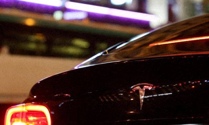 A Tesla logo is seen on a Parisian taxi car in Paris, France, on Dec. 14, 2021. (Sarah Meyssonnier/Reuters)