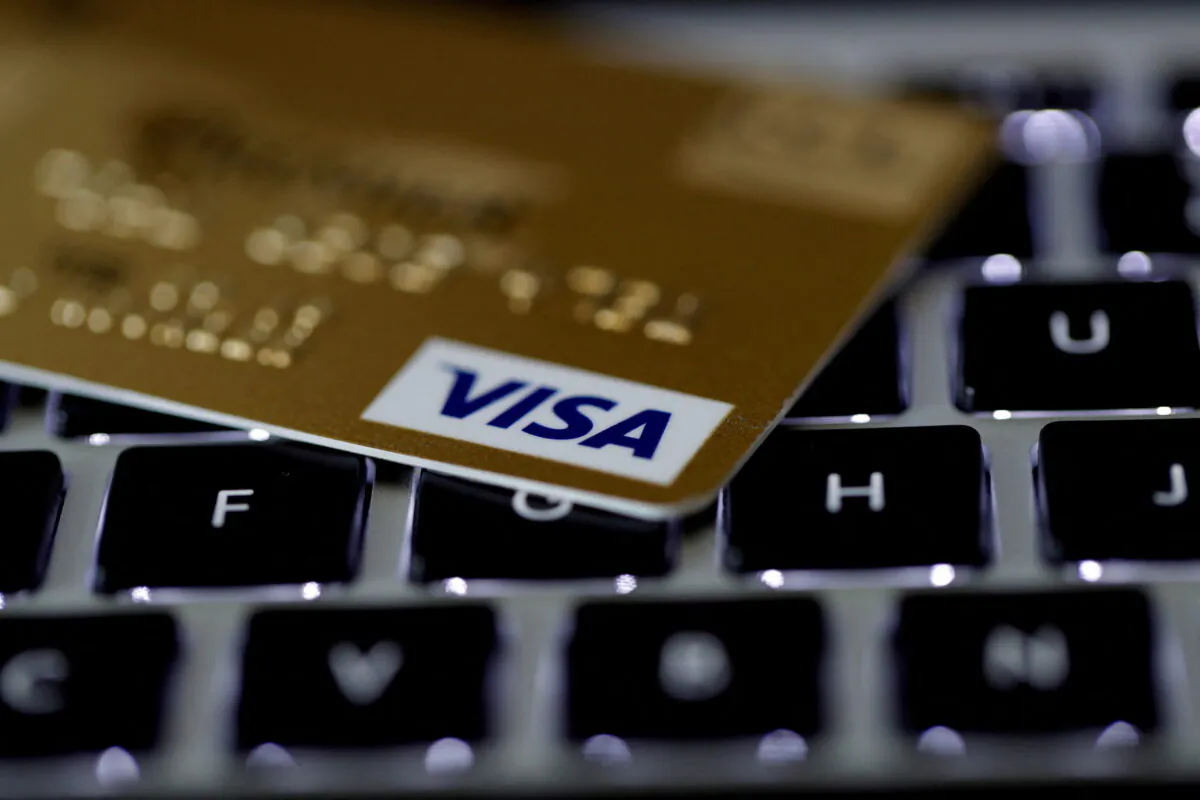 A Visa credit card is seen on a computer keyboard in this picture illustration taken on Sept. 6, 2017. (Philippe Wojazer/Illustration/Reuters)
