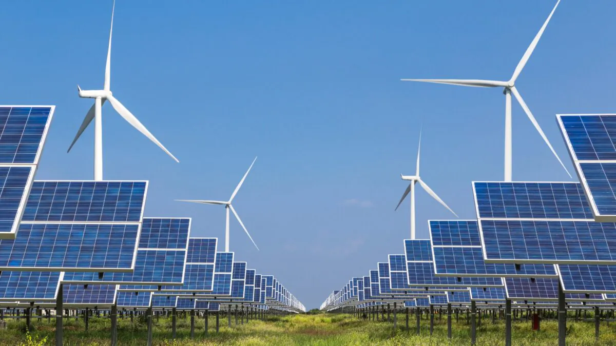 An array of solar panels and wind turbines. (Soonthorn/Adobe Stock)