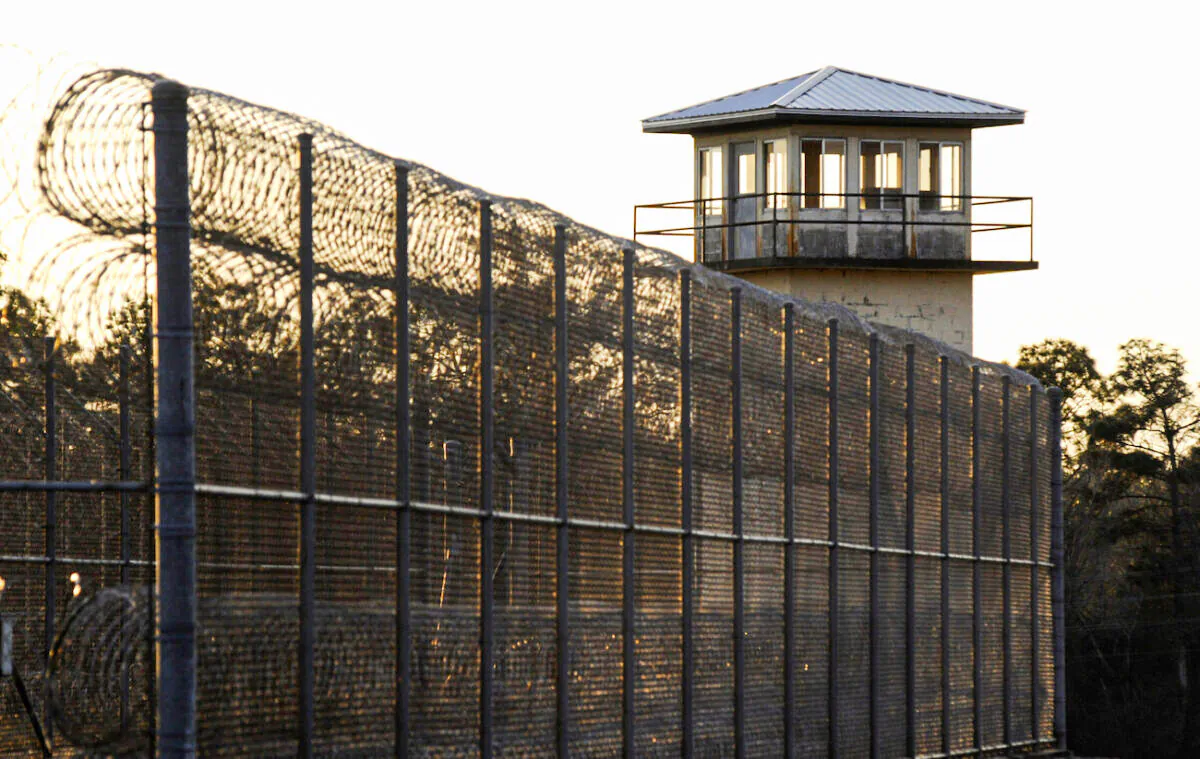 The sun sets behind Holman Prison in Atmore, Ala., on Jan., 27, 2022. (Jay Reeves/AP Photo)