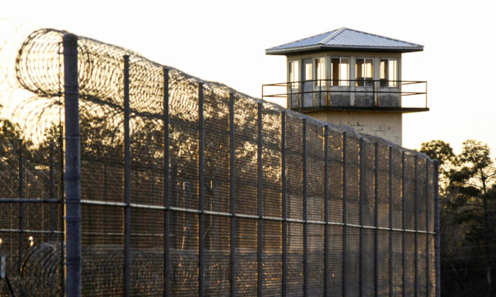 The sun sets behind Holman Prison in Atmore, Ala., on Jan., 27, 2022. (Jay Reeves/AP Photo)