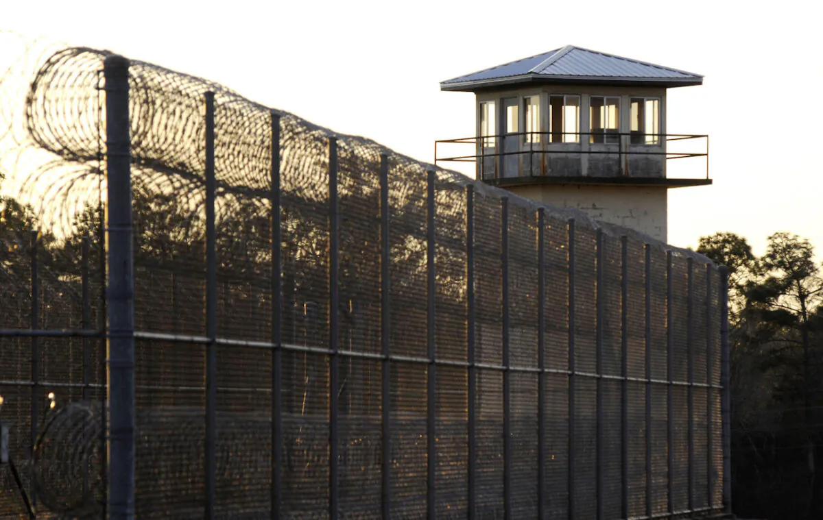 The sun sets behind Holman Prison in Atmore, Ala., on Jan., 27, 2022. (AP Photo/Jay Reeves)