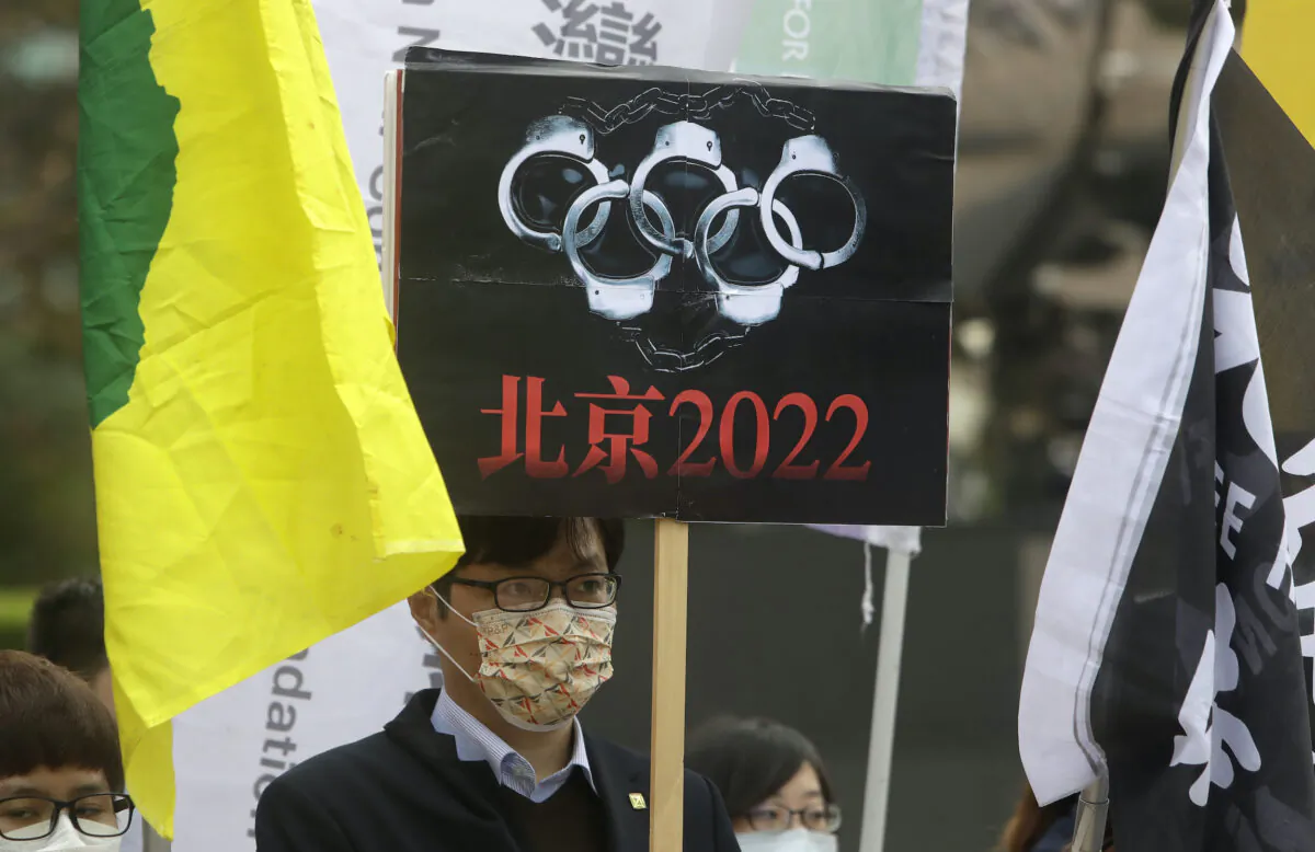 Human right groups gather on the United Nations international Human Rights Day to call for a boycott of the Beijing Winter Olympics 2022, in front of the Bank of China building in Taipei, Taiwan, on Dec. 10, 2021. (Chiang Ying-ying/AP Photo)