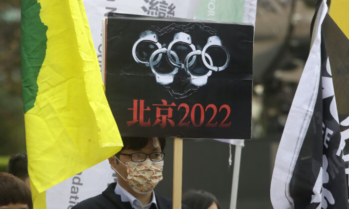 Human right groups gather on the United Nations international Human Rights Day to call for a boycott of the Beijing Winter Olympics 2022, in front of the Bank of China building in Taipei, Taiwan, on Dec. 10, 2021. (Chiang Ying-ying/AP Photo)