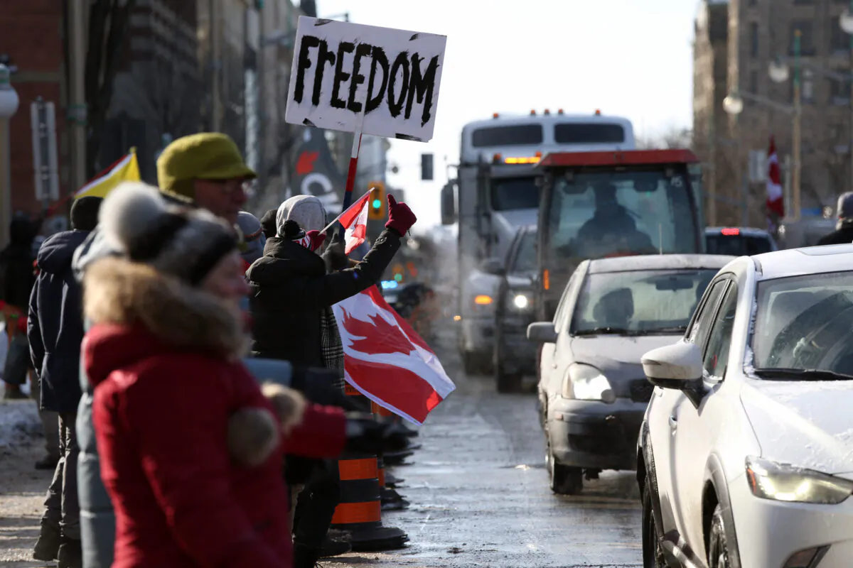 Supporters of the Freedom Convoy protest against COVID-19 vaccine mandates and restrictions in front of Parliament in Ottawa on Jan. 28, 2022. (Dave Chan/AFP via Getty Images)