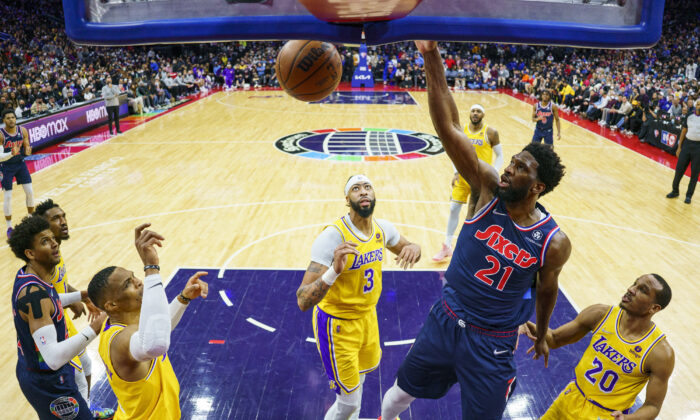 Philadelphia 76ers' Joel Embiid, center right, dunks during the first half of an NBA basketball game against the Los Angeles Lakers in Philadelphia on Jan. 27, 2022. (Chris Szagola/AP Photo)