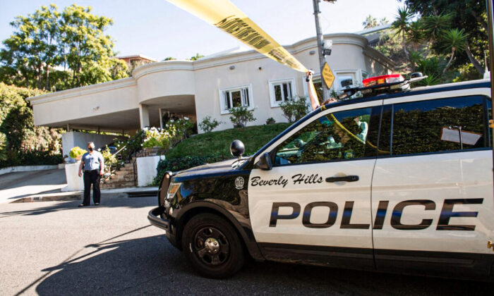 Police tape blocks access to the scene of a burglary and shooting in Beverly Hills, Calif., on Dec. 1, 2021. (Valerie Macon/AFP via Getty Images)