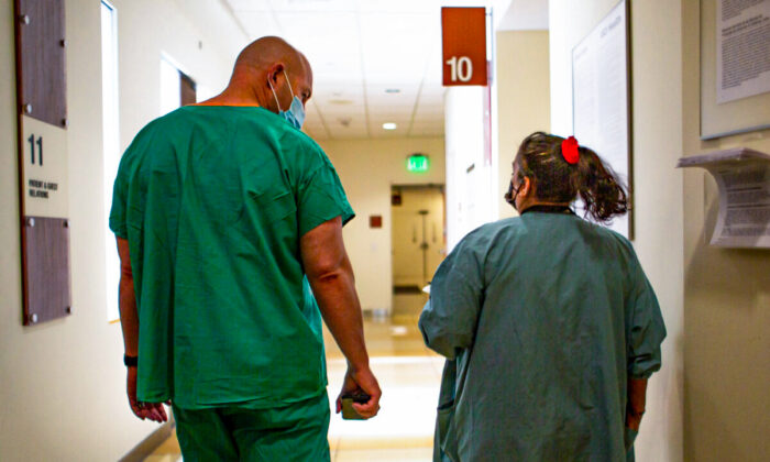 Hospital staff members walk down a hall at UCI Medical Center in Orange., Calif., on Dec. 16, 2020. (John Fredricks/The Epoch Times)