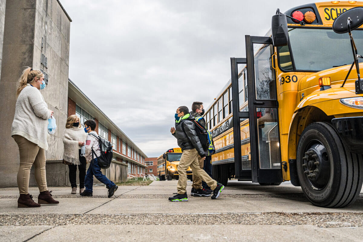 File photo: Teachers greet their students as they get off the bus at Carter Traditional Elementary School in Louisville, Kentucky, on Jan. 24, 2022. (Jon Cherry/Getty Images)