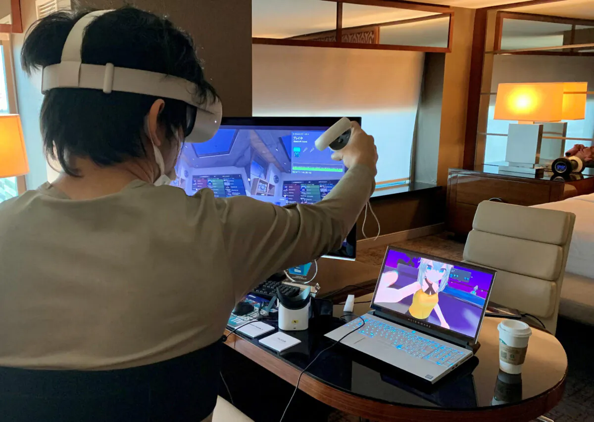Takuma Iwasa, Shiftall CEO, demonstrates Haritora X, a full body tracking system for VR, at the Consumer Electronics Show (CES) in Las Vegas on Jan. 5, 2022. A jacket equipped with sensors that let wearers feel hugs or even punches encountered in virtual reality was among the innovations giving the metaverse a more realistic edge at the Consumer Electronics Show. (Julie Jammot/AFP via Getty Images)