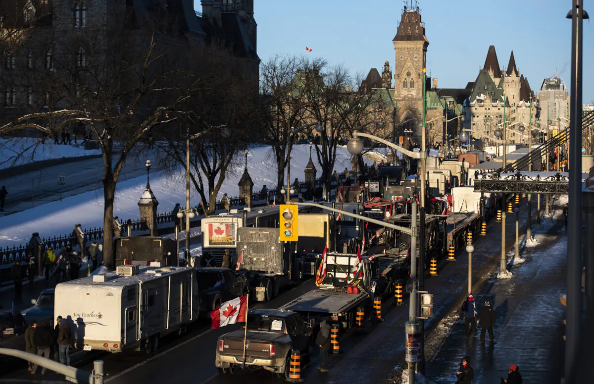 Trucks participating in a cross-country convoy protesting Canada's COVID-19 vaccine mandates, dubbed Freedom Convoy 2022, are parked on Wellington Street in front of Parliament Hill in Ottawa on Jan. 28, 2022. (Justin Tang/The Canadian Press)