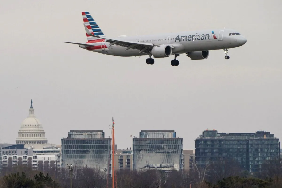 An American Airlines aircraft flies past the U.S. Capitol before landing at Reagan National Airport in Arlington, Va., on Jan. 24, 2022. (Joshua Roberts/Reuters)