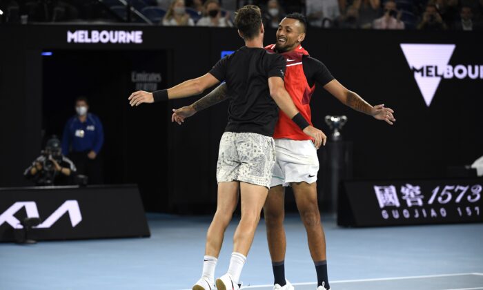 Nick Kyrgios, (R), and Thanasi Kokkinakis of Australia celebrate after defeating compatriots Matthew Ebden and Max Purcell in the men's doubles final at the Australian Open tennis championships  in Melbourne, Australia. on Jan. 29, 2022. (Andy Brownbill/AP Photo)