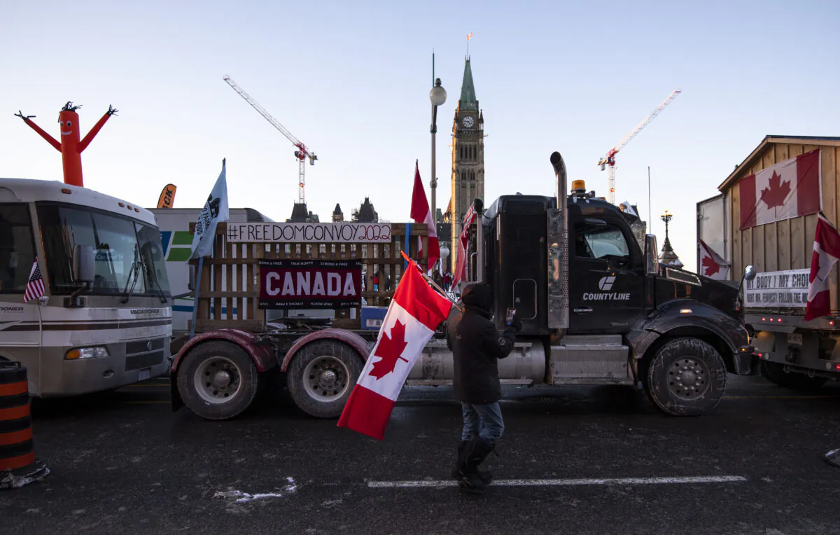 Trucks participating in a cross-country convoy protesting COVID-19 mandates and restrictions are parked on Wellington Street in front of Parliament Hill in Ottawa, on Jan. 28, 2022. (The Canadian Press/Justin Tang)