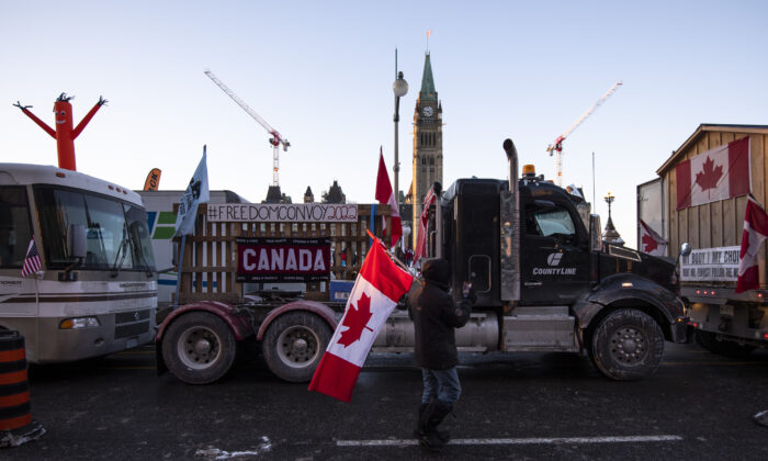 Trucks participating in a cross-country convoy protesting COVID-19 mandates and restrictions are parked on Wellington Street in front of Parliament Hill in Ottawa, on Jan. 28, 2022. (The Canadian Press/Justin Tang)