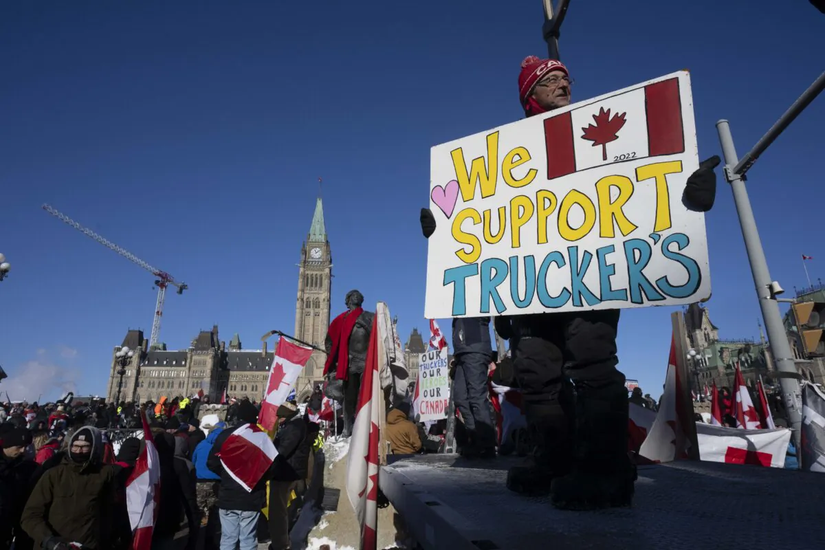 Protesters participating in the truck convoy protest against COVID-19 mandates and restrictions gather on Parliament Hill in Ottawa on Jan. 29, 2022. (The Canadian Press/Adrian Wyld)