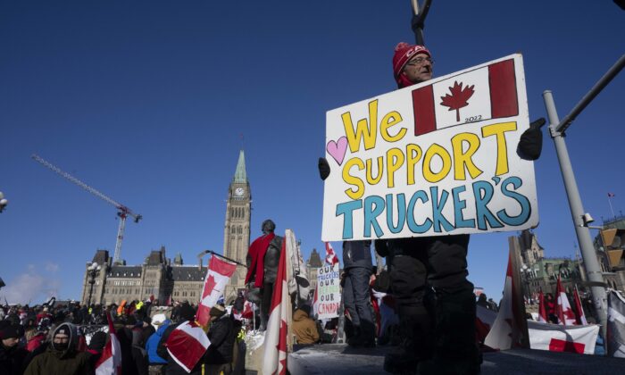 Protesters participating in the truck convoy protest against COVID-19 mandates and restrictions gather on Parliament Hill in Ottawa on Jan. 29, 2022. (The Canadian Press/Adrian Wyld)