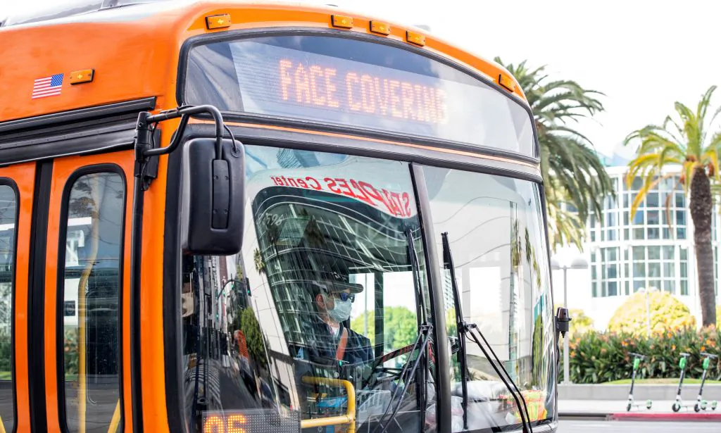 A man drives a bus in the downtown area in Los Angeles, Calif., on March 8, 2021. (Valerie Macon/AFP via Getty Images)