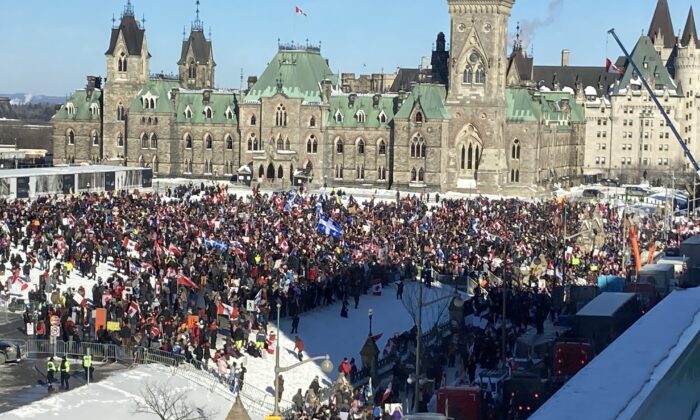 People gather in Parliament Hill as the trucker convoy protesting COVID-19 mandates and restrictions stages demonstrations in Ottawa on Jan. 29, 2022.  (Limin Zhou/The Epoch Times)