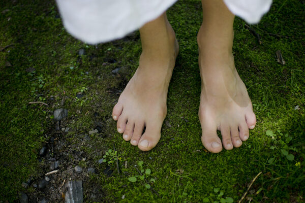 A,Young,Girl's,Bare,Feet,Feeling,The,Softness,Of,The