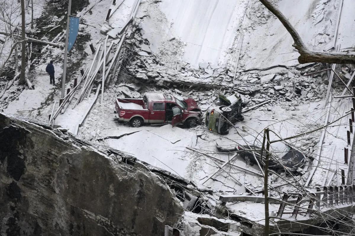 Vehicles that were on a bridge when it collapsed are visible, in Pittsburgh's East End on Jan. 28, 2022. (Gene J. Puskar/AP Photo)