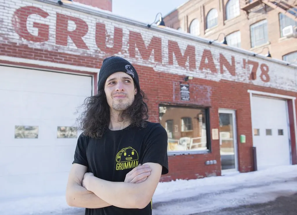 Milovan Danielou, a former cook at Grumman 78 poses outside the closed down restaurant in Montreal, Jan. 28, 2022. (The Canadian Press/Graham Hughes.)