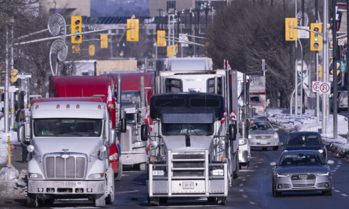 Trucks from the convoy protest against COVID-19 mandates and restrictions are parked on a road in Ottawa on Jan. 30, 2022.  (The Canadian Press/Adrian Wyld)