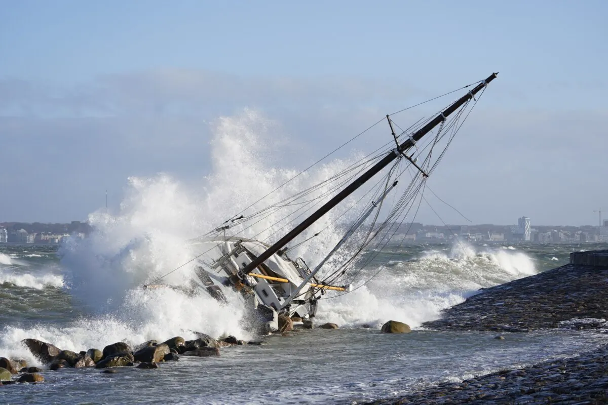 Waves crash against a sailboat in Elsinore, Denmark, on Jan. 30, 2022. (Keld Navntoft/Ritzau Scanpix via AP)