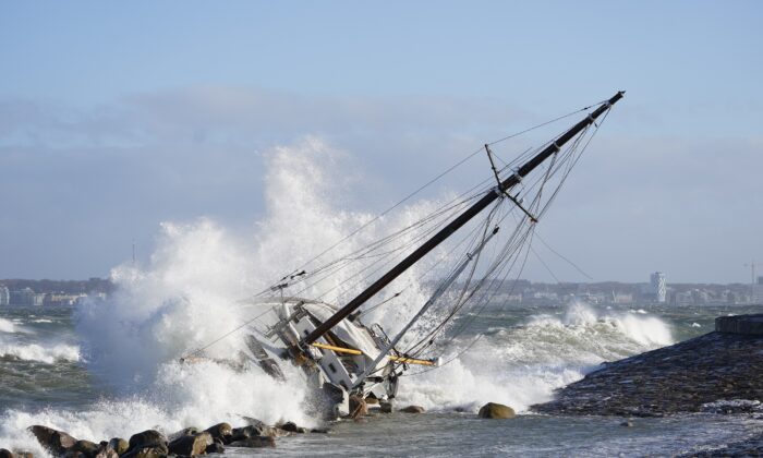 Waves crash against a sailboat in Elsinore, Denmark, on Jan. 30, 2022. (Keld Navntoft/Ritzau Scanpix via AP)