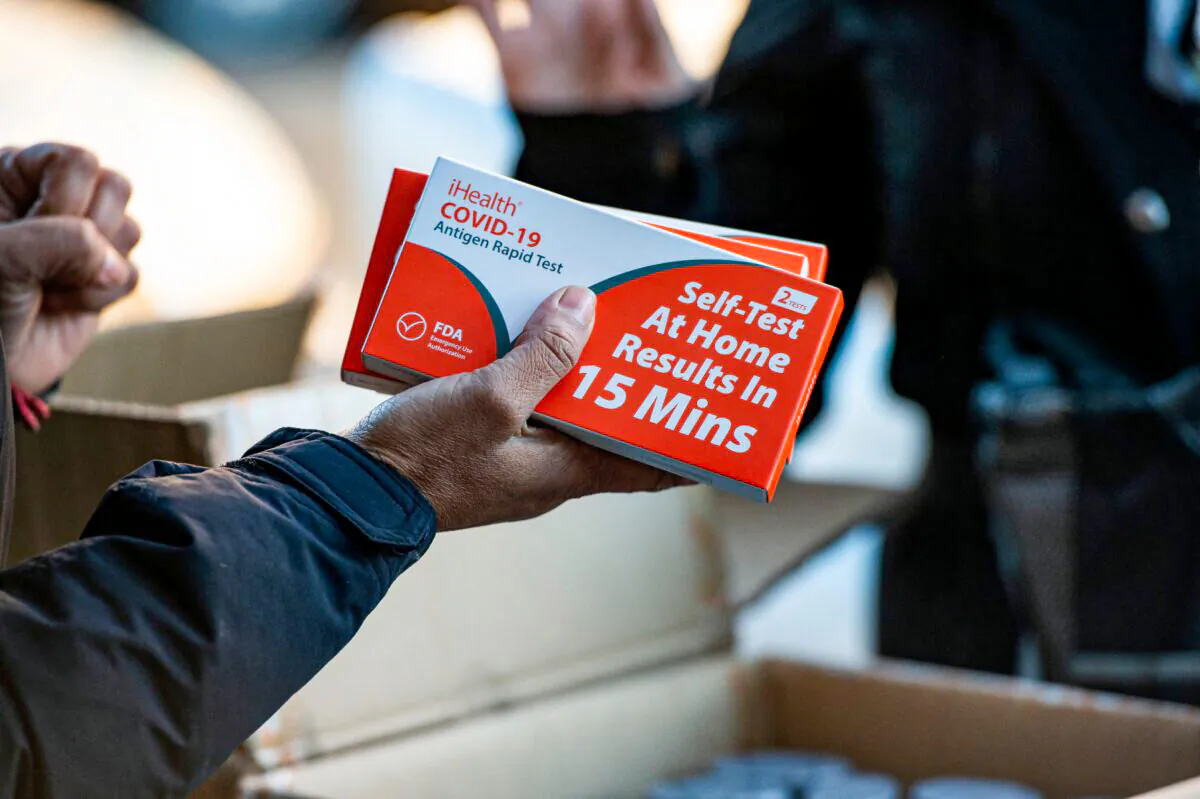 Rapid at-home COVID-19 test kits are distributed by the GreenRoots environmental protection organization and Chelsea Community Connections in Chelsea, Mass., on Dec. 17, 2021. (Joseph Prezioso/AFP via Getty Images)