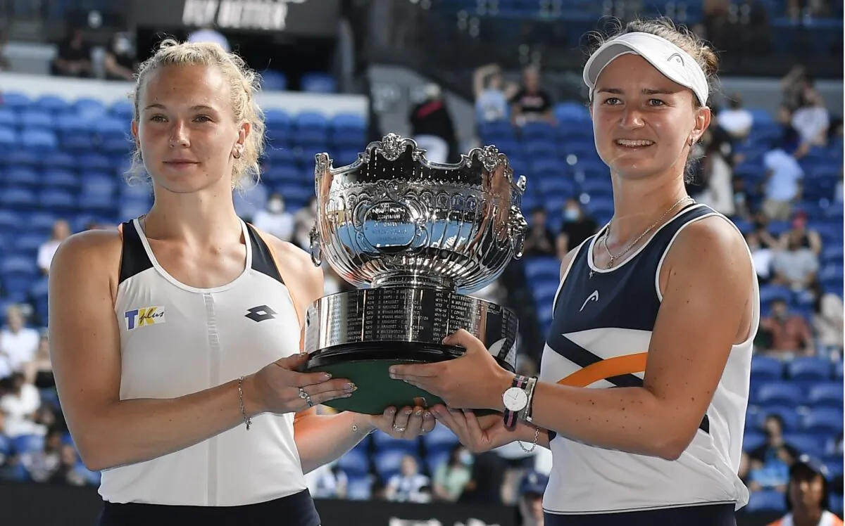 Barbora Krejcikova and Katerina Siniakova of the Czech Republic hold their trophy in the women's doubles final, at the Australian Open tennis championships in Melbourne on Jan. 30, 2022. (Andy Brownbill/AP Photo)