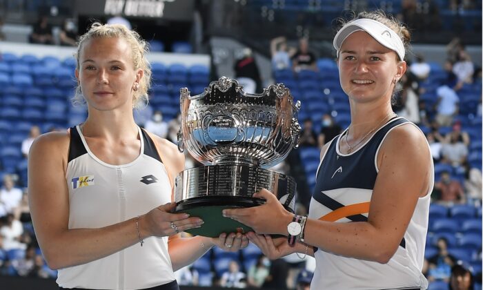 Barbora Krejcikova and Katerina Siniakova of the Czech Republic hold their trophy in the women's doubles final, at the Australian Open tennis championships in Melbourne on Jan. 30, 2022. (Andy Brownbill/AP Photo)