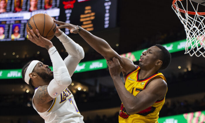 Atlanta Hawks forward Onyeka Okongwu (17) blocks Los Angeles Lakers forward Carmelo Anthony (7) during the second half of an NBA basketball game in Atlanta on Jan. 30, 2022. (Hakim Wright Sr./AP Photo)