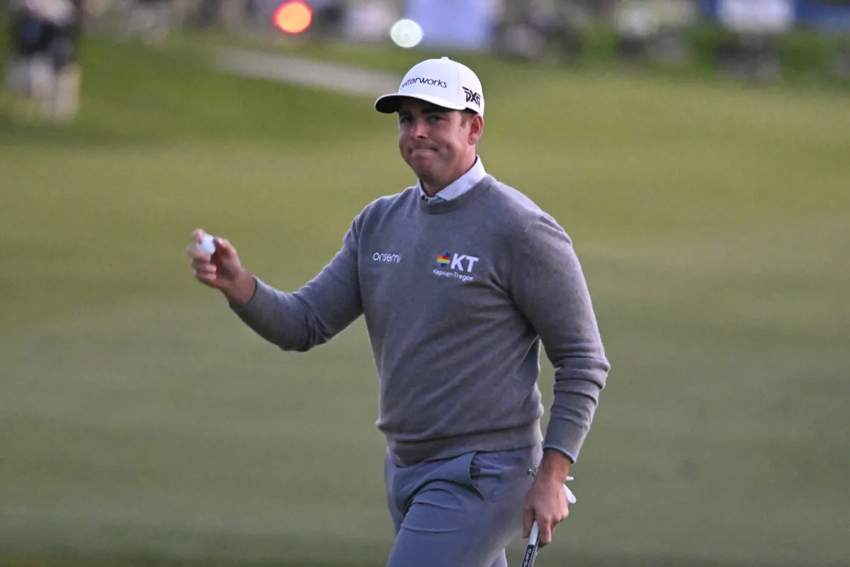 Luke List holds the ball up after hitting a birdie putt on the 18th hole of the South Course during the final round of the Farmers Insurance Open golf tournament in San Diego on Jan. 29, 2022. (Denis Poroy/AP Photo)
