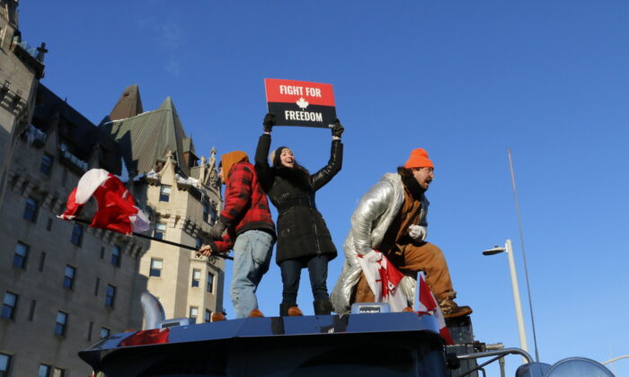 Protesters stand atop a truck in downtown Ottawa on Jan. 29, 2022, at the beginning of the Freedom Convoy demonstration. (Noé Chartier/The Epoch Times)