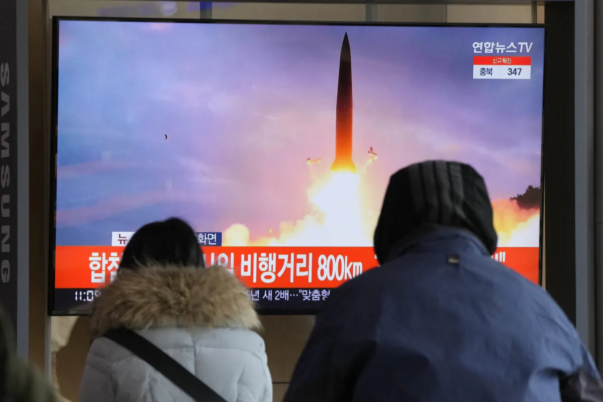 People watch a TV showing a file image of North Korea's missile launch during a news program at the Seoul Railway Station in Seoul, South Korea, on Jan. 30, 2022. (Ahn Young-joon/AP Photo)