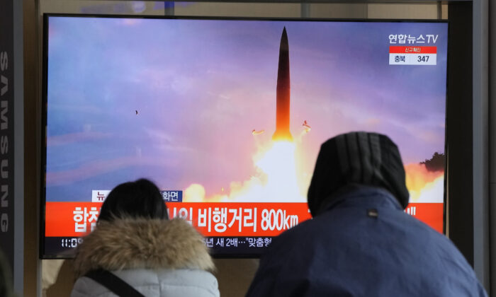 People watch a TV showing a file image of North Korea's missile launch during a news program at the Seoul Railway Station in Seoul, South Korea, on Jan. 30, 2022. (Ahn Young-joon/AP Photo)