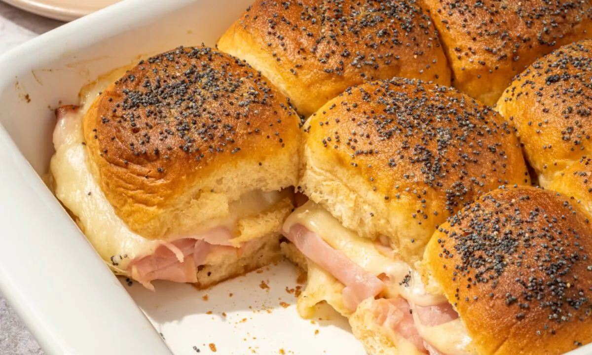 These sliders have it all: sweet slices of ham, gooey Swiss cheese, squishy Hawaiian rolls, and a savory butter drizzle. (Eric Kleinberg/TNS)
