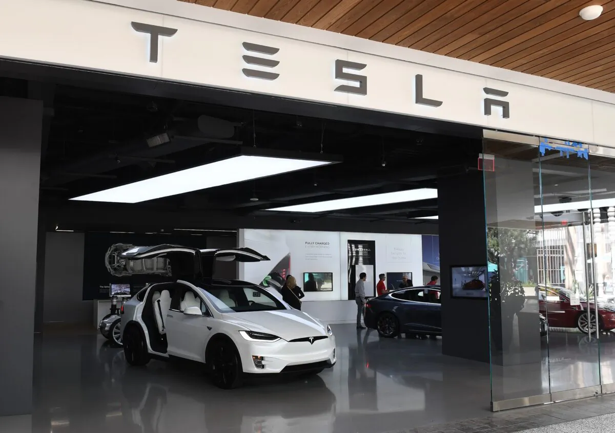 People stand in a Tesla showroom at a shopping mall in La.,, on April 25, 2019. (Mark Ralston/AFP via Getty Images)