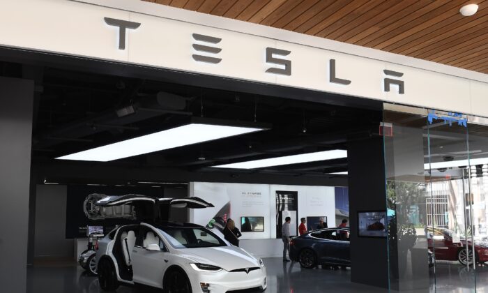 People stand in a Tesla showroom at a shopping mall in La.,, on April 25, 2019. (Mark Ralston/AFP via Getty Images)
