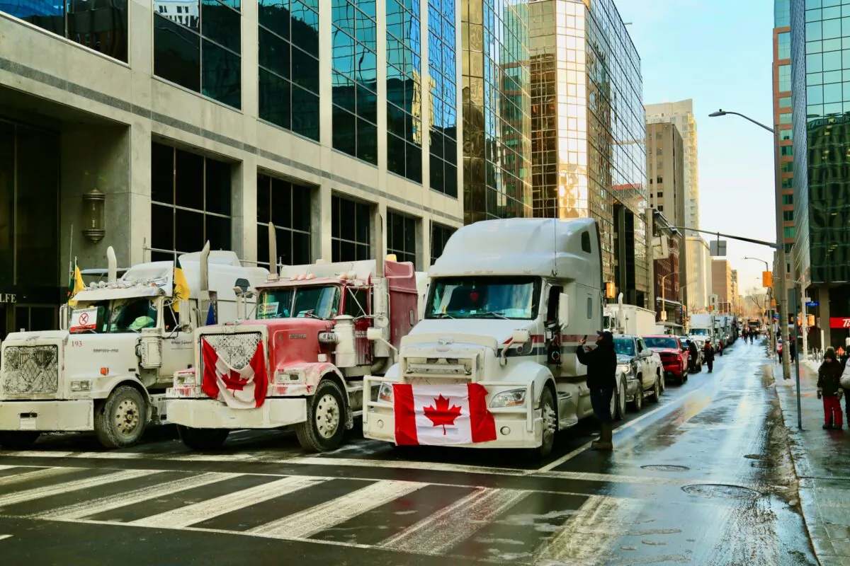 Trucks parked close to the Parliament as protesters takes part in demonstrations against COVID-19 mandates and restrictions in Ottawa on Jan. 31, 2022. (Jonathan Ren/The Epoch Times)