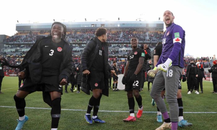Soccer Football - World Cup - CONCACAF Qualifiers - Canada v United States - Tim Hortons Stadium, Hamilton, Canada - Jan. 30, 2022. Canada's Sam Adekugbe and Milan Borjan celebrate after the match (Reuters/Carlos Osorio)