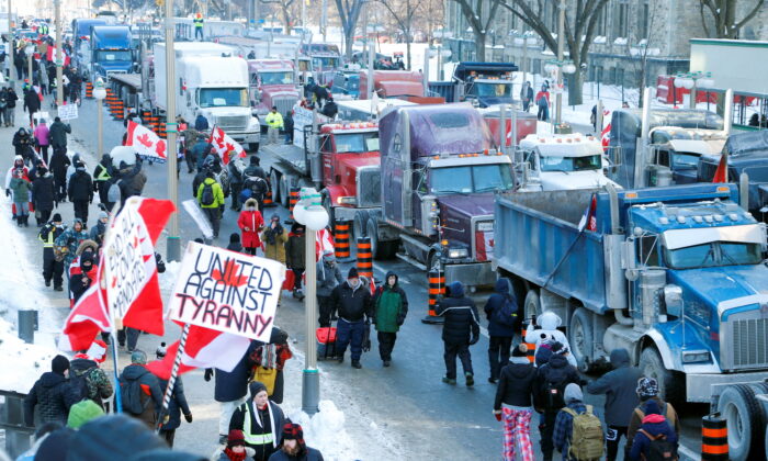 Trucks sit parked on Wellington St. near parliament as truckers and their supporters took part in a convoy to protest COVID-19 vaccine mandates for cross-border truck drivers in Ottawa, Ontario, Canada, Jan. 29, 2022. (Patrick Doyle/ Reuters)