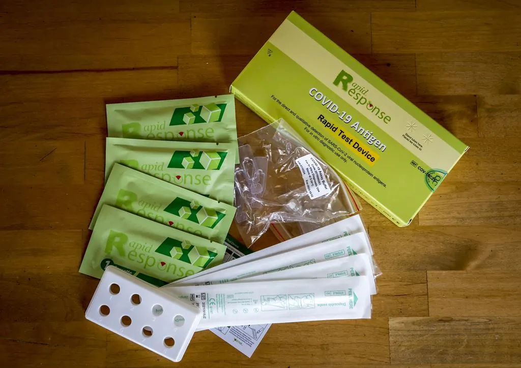 The contents of a COVID-19 antigen rapid test kit are pictured in Calgary, Alta., on Jan. 4, 2022. (The Canadian Press/Jeff McIntosh)