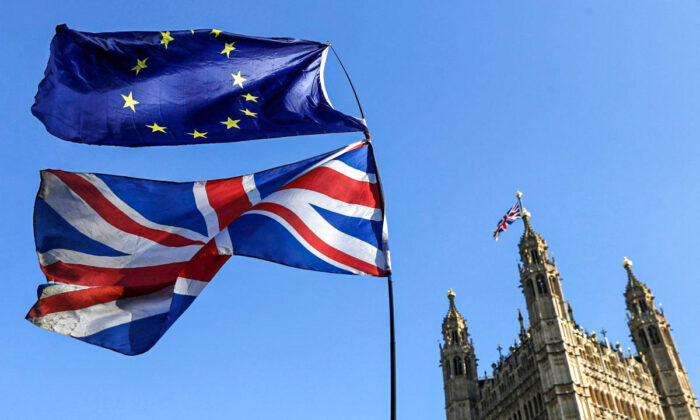 The flag of the European Union and the British national flags are flown on poles during a demonstration outside the Palace of Westminster in London on Feb. 27, 2019. (Alastair Grant/AP Photo)