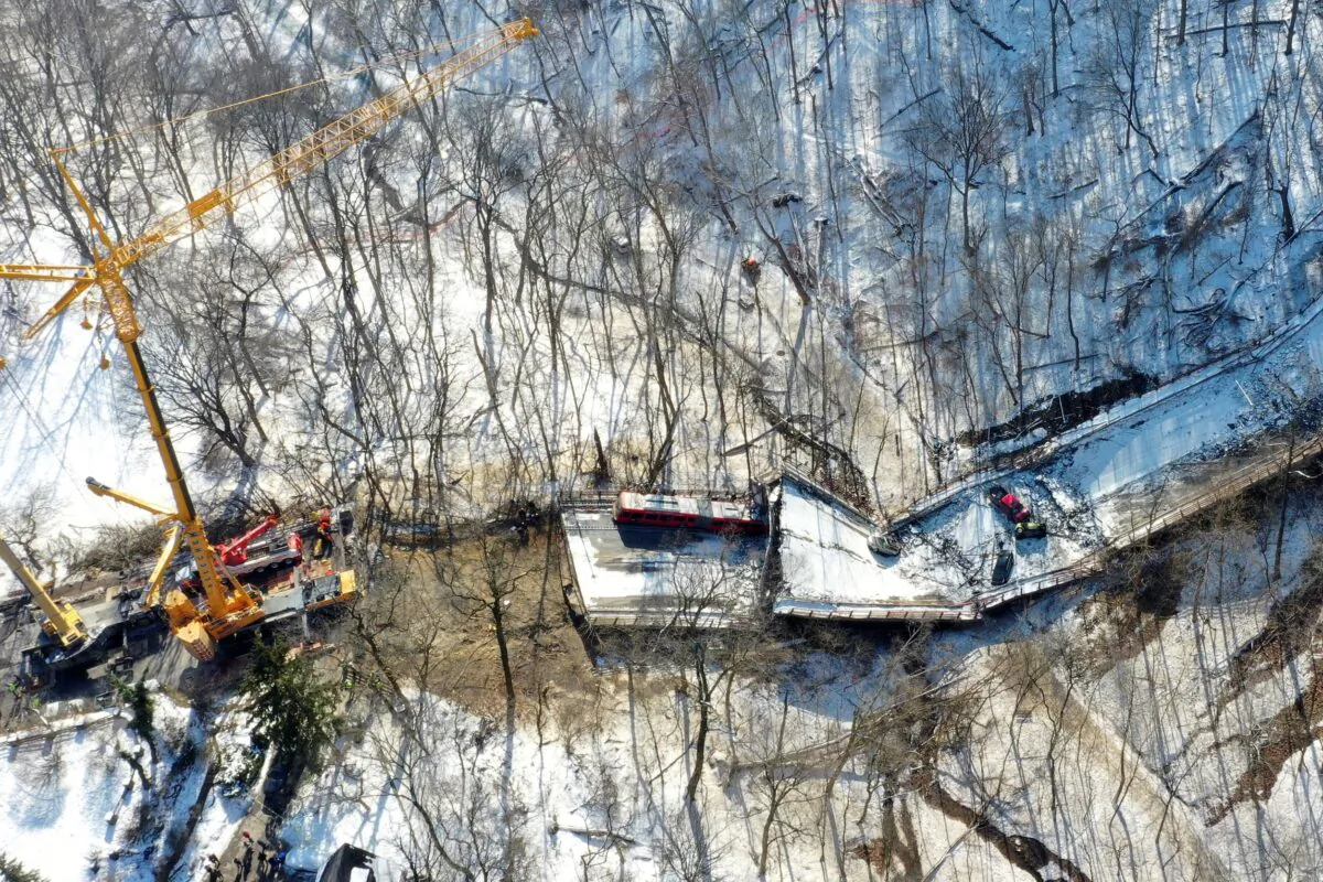 A crane is in place on as part of clean up efforts at the Fern Hollow Bridge that collapsed in Pittsburgh on Jan. 31, 2022. (Gene J. Puskar/AP Photo)
