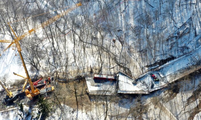 A crane is in place on as part of clean up efforts at the Fern Hollow Bridge that collapsed in Pittsburgh, on Jan. 31, 2022. (Gene J. Puskar/AP Photo)